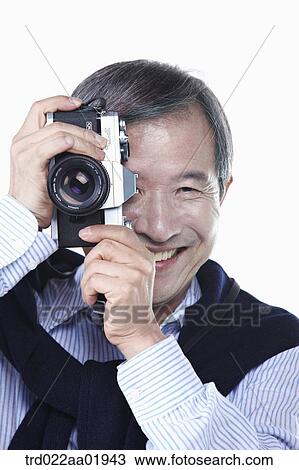 An old man photographing with camera View Large Photo Image Stock Image - An old man photographing with camera. Fotosearch