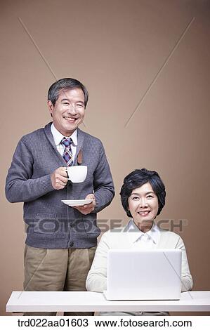 An old man with a cup of coffee and old woman with laptop View Large Photo Image Stock Image - An old man with a cup of coffee and old woman with laptop. Fotosearch