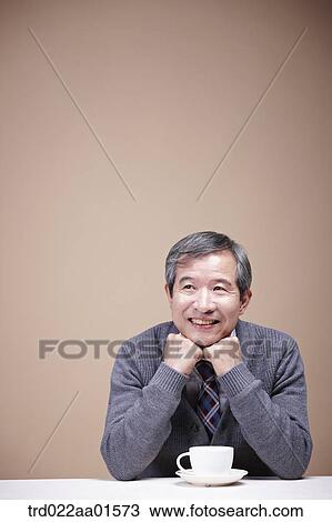 An old man with a cup of coffee View Large Photo Image Stock Image - An old man with a cup of coffee. Fotosearch