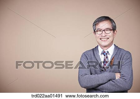 An old man with his arms folded View Large Photo Image Stock Image - An old man with his arms folded. Fotosearch