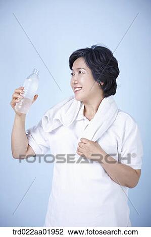 An old woman drinking a bottle of water View Large Photo Image Stock Image - An old woman drinking a bottle of water. Fotosearch