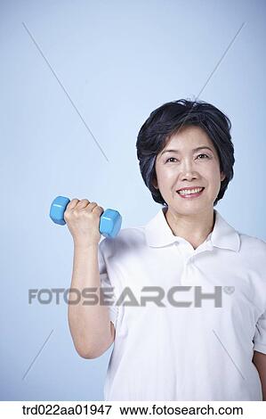 An old woman exercising with dumbbell View Large Photo Image Stock Photo - An old woman exercising with dumbbell . Fotosearch