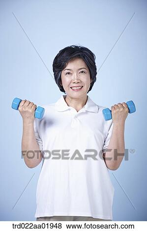 An old woman exercising with dumbbell View Large Photo Image Stock Photo - An old woman exercising with dumbbell . Fotosearch
