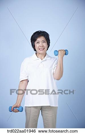An old woman exercising with dumbbell View Large Photo Image Stock Photograph - An old woman exercising with dumbbell . Fotosearch