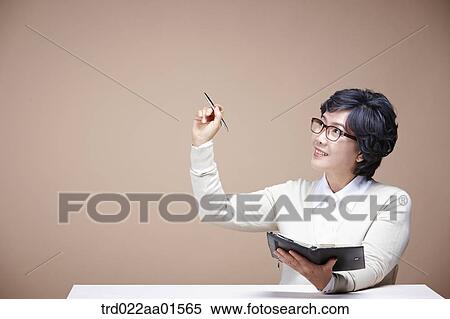 An old woman holding the pen and planner View Large Photo Image Stock Photography - An old woman holding the pen and planner. Fotosearch