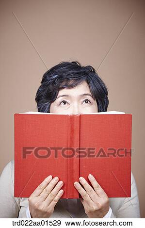 An old woman looking up with red book View Large Photo Image Stock Photo - An old woman looking up with red book. Fotosearch