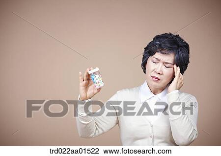 An old woman suffering from headache with medicine View Large Photo Image Stock Image - An old woman suffering from headache with medicine. Fotosearch