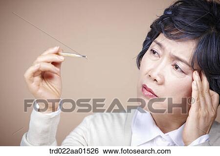An old woman suffering from headache with thermometer View Large Photo Image Stock Photograph - An old woman suffering from headache with thermometer. Fotosearch