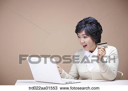 An old woman surprised at laptop monitor with credit card View Large Photo Image Stock Image - An old woman surprised at laptop monitor with credit card. Fotosearch