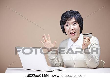 An old woman surprised with laptop and credit card View Large Photo Image Stock Photograph - An old woman surprised with laptop and credit card. Fotosearch