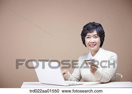 An old woman with credit card and laptop View Large Photo Image Stock Image - An old woman with credit card and laptop. Fotosearch