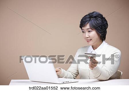 An old woman with credit card and laptop View Large Photo Image Stock Image - An old woman with credit card and laptop. Fotosearch