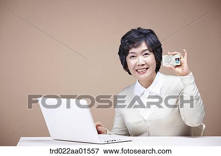 An old woman with credit card and laptop View Large Photo Image Stock Photo - An old woman with credit card and laptop. Fotosearch