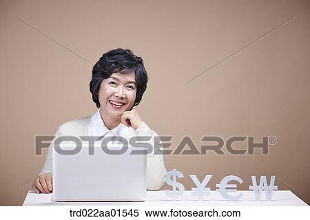 An old woman with foreign currency and laptop View Large Photo Image Stock Photography - An old woman with foreign currency and laptop . Fotosearch
