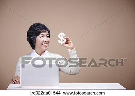 An old woman with money and laptop View Large Photo Image Picture - An old woman with money and laptop . Fotosearch