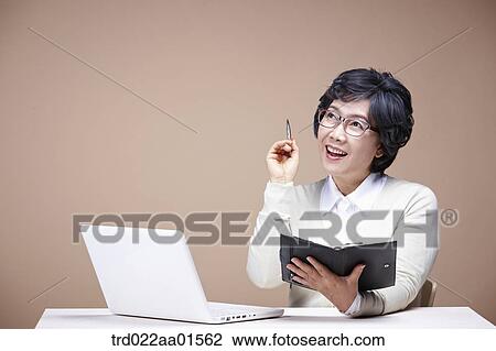 An old woman with planner and laptop View Large Photo Image Stock Image - An old woman with planner and laptop . Fotosearch