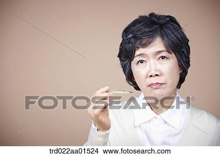 An old woman with thermometer View Large Photo Image Picture - An old woman with thermometer. Fotosearch