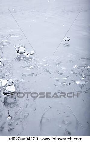 Stock Photo - Dropping water onto the surface of water. Fotosearch
