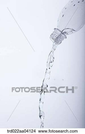 Pouring water from the bottle View Large Photo Image Picture - Pouring water from the bottle. Fotosearch