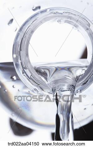 Stock Image - Pouring water from the bottle. Fotosearch