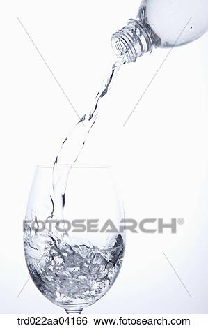 Pouring water from the bottle to the glass View Large Photo Image Stock Photograph - Pouring water from the bottle to the glass. Fotosearch
