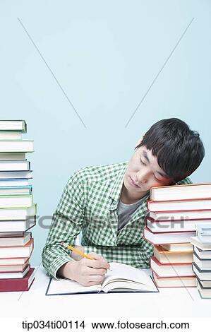 Sleeping man while studying at the desk View Large Photo Image Picture - Sleeping man while studying at the desk. Fotosearch