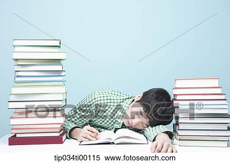Stock Photography - Sleeping man while studying at the desk. Fotosearch