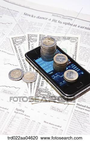 Smartphone and money on the newspaper View Large Photo Image Stock Image - Smartphone and money on the newspaper. Fotosearch
