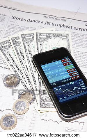 Smartphone and money on the newspaper View Large Photo Image Stock Photo - Smartphone and money on the newspaper. Fotosearch