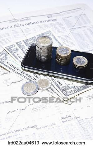 Stock Photo - Smartphone and money on the newspaper. Fotosearch