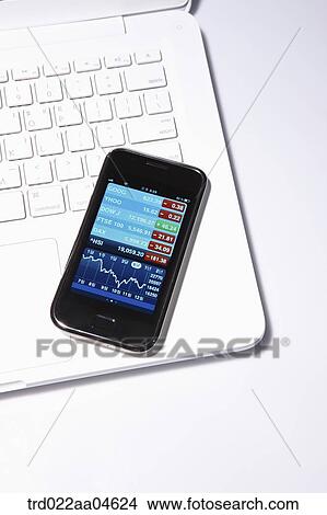 Smartphone on the white laptop View Large Photo Image Picture - Smartphone on the white laptop . Fotosearch