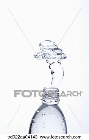 Stock Image - Spring up water from the bottle. Fotosearch