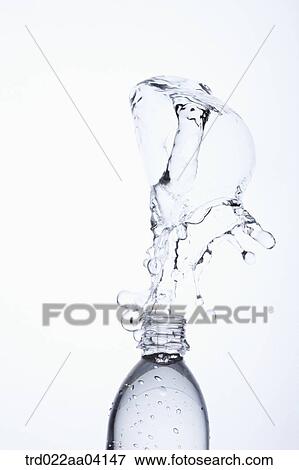 Stock Photo - Spring up water from the bottle. Fotosearch