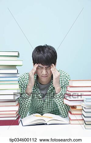 Stressful man while studying at the desk View Large Photo Image Stock Image - Stressful man while studying at the desk. Fotosearch