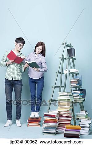 Stock Image - Studying man and woman and competing each other. Fotosearch