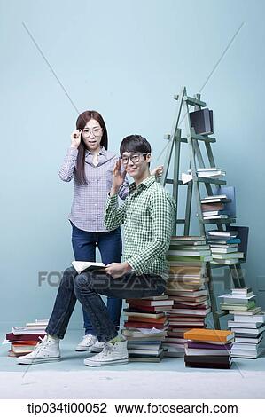 Stock Image - Studying man and woman with the glasses on . Fotosearch