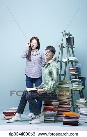 Studying man and woman with the glasses on View Large Photo Image Stock Image - Studying man and woman with the glasses on . Fotosearch