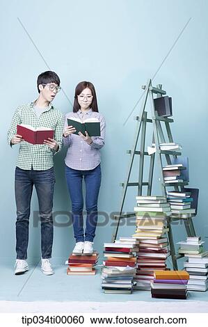 Stock Image - Studying man and woman with the glasses on . Fotosearch