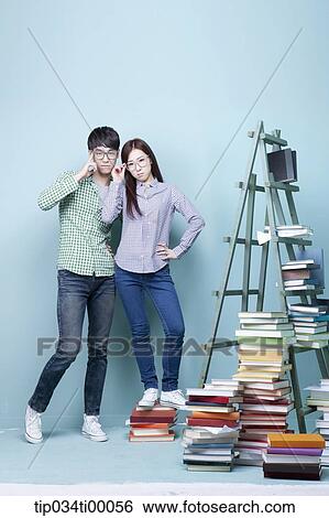 Studying man and woman with the glasses on View Large Photo Image Stock Photograph - Studying man and woman with the glasses on . Fotosearch