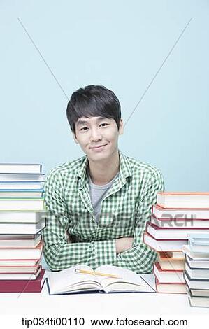 Stock Image - Studying man at the desk. Fotosearch