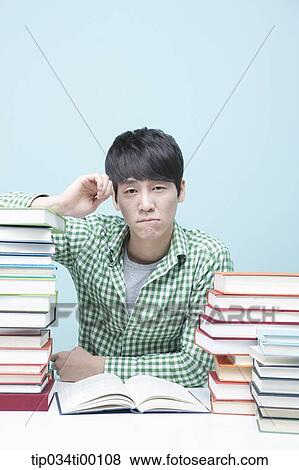 Stock Photo - Studying man at the desk. Fotosearch