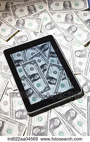 Tablet PC and bill of dollar View Large Photo Image Stock Photo - Tablet PC and bill of dollar . Fotosearch