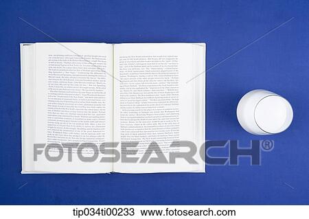 Stock Image - The book and a glass of milk. Fotosearch