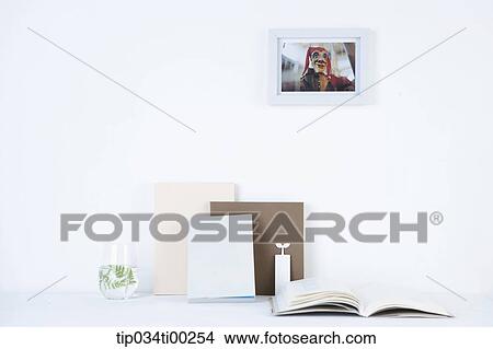 Picture - The book and photograph on the wall. Fotosearch