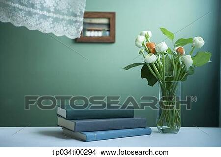 Picture - The book and the flower in glass. Fotosearch