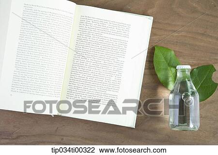The book and the glass bottle on the leaves View Large Photo Image Stock Image - The book and the glass bottle on the leaves. Fotosearch