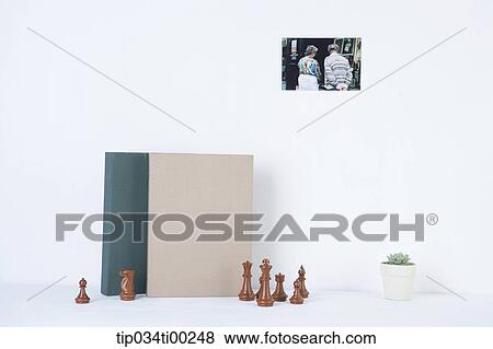 The book, chessmen, pot, and photograph on the wall View Large Photo Image Stock Photo - The book, chessmen, pot, and photograph on the wall. Fotosearch