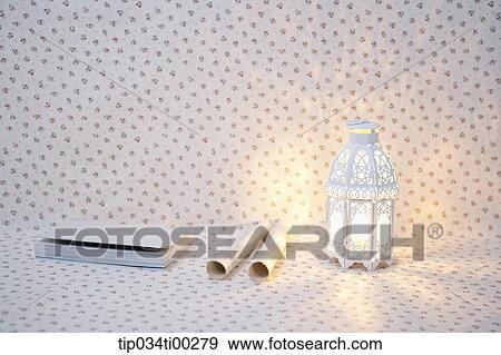 Stock Photo - The book, rolled paper, and light. Fotosearch