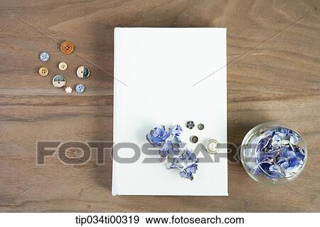 Stock Photo - The book with purple flower and button around. Fotosearch