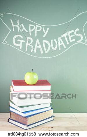 Stock Photo - The books and the celebrating word on black board. Fotosearch